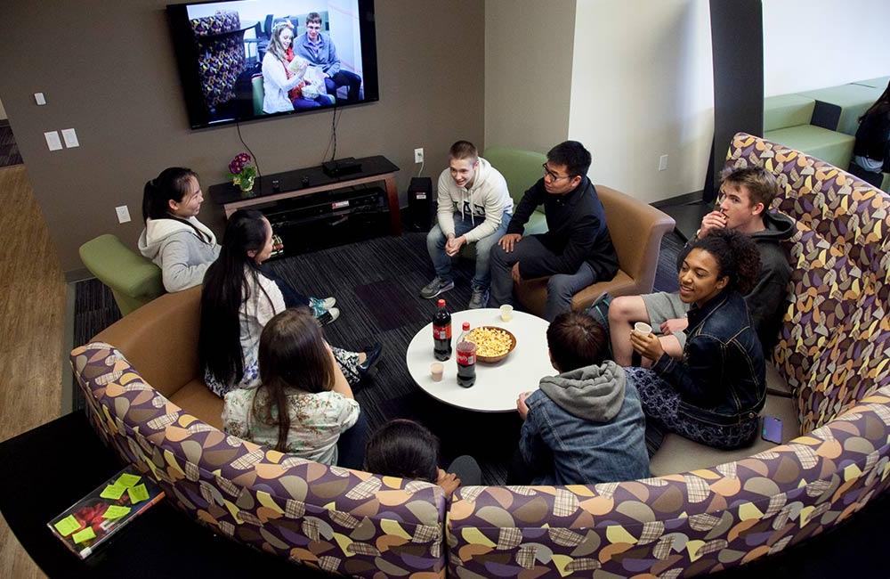 students conversing in dorm great hall